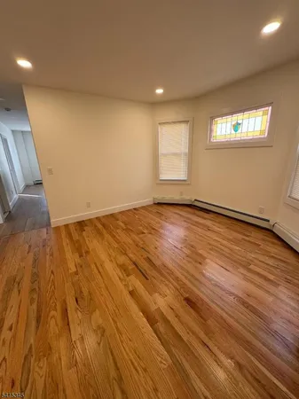 a view of an empty room and wooden floor