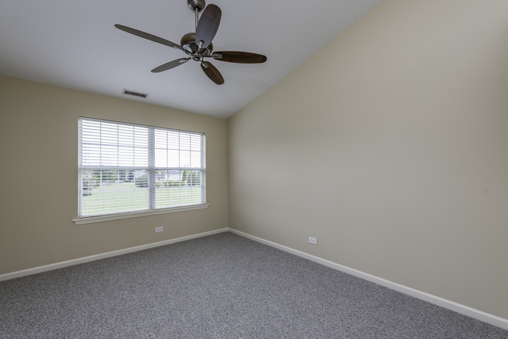 17876 Braewick Road Gurnee, IL 60031 - Photo 12 of 28 an empty room with a window and a fan