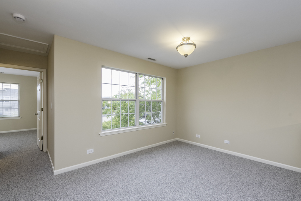17876 Braewick Road Gurnee, IL 60031 - Photo 13 of 28 an empty room with a window