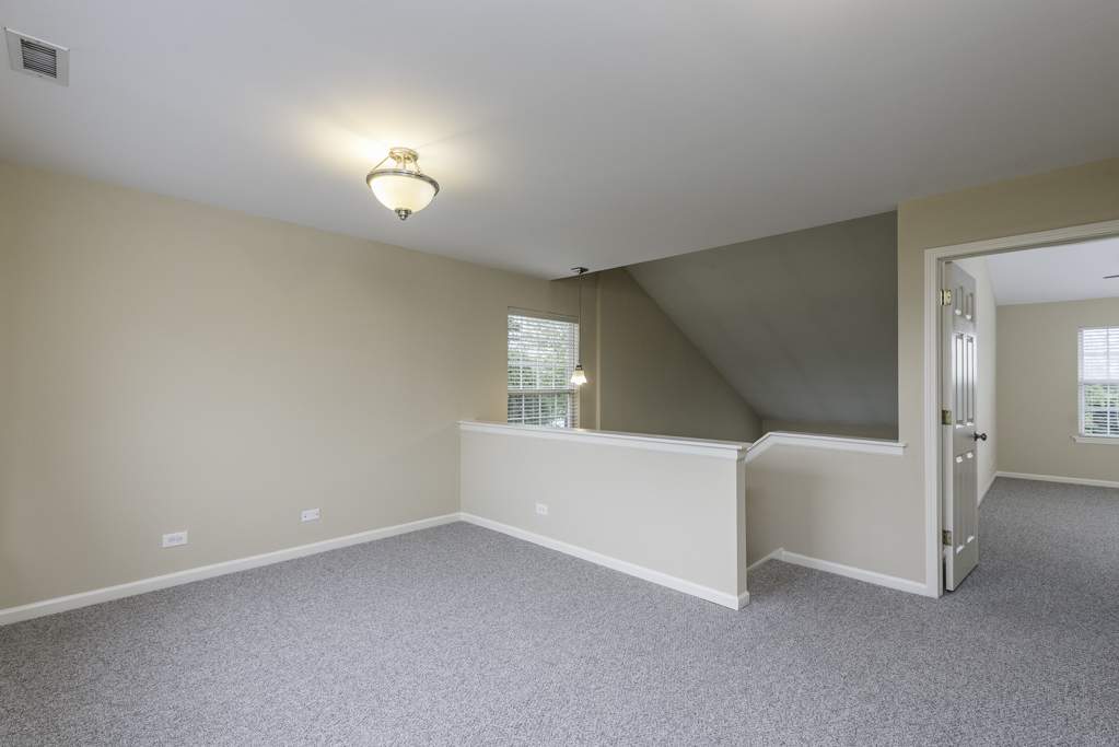 17876 Braewick Road Gurnee, IL 60031 - Photo 14 of 28 a view of a livingroom with an empty space and a window
