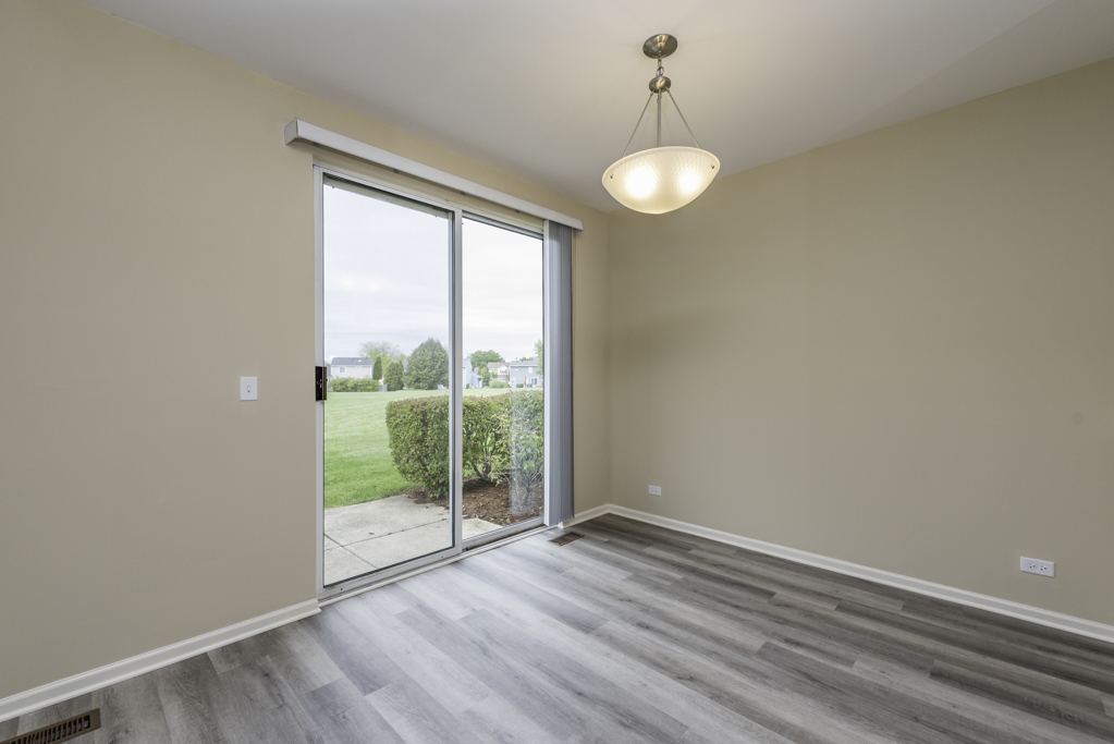 17876 Braewick Road Gurnee, IL 60031 - Photo 19 of 28 a view of an empty room with wooden floor and a window