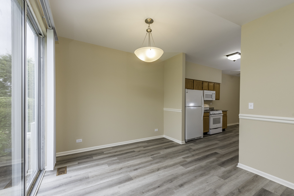 17876 Braewick Road Gurnee, IL 60031 - Photo 20 of 28 a view of a kitchen with wooden floor and a large window