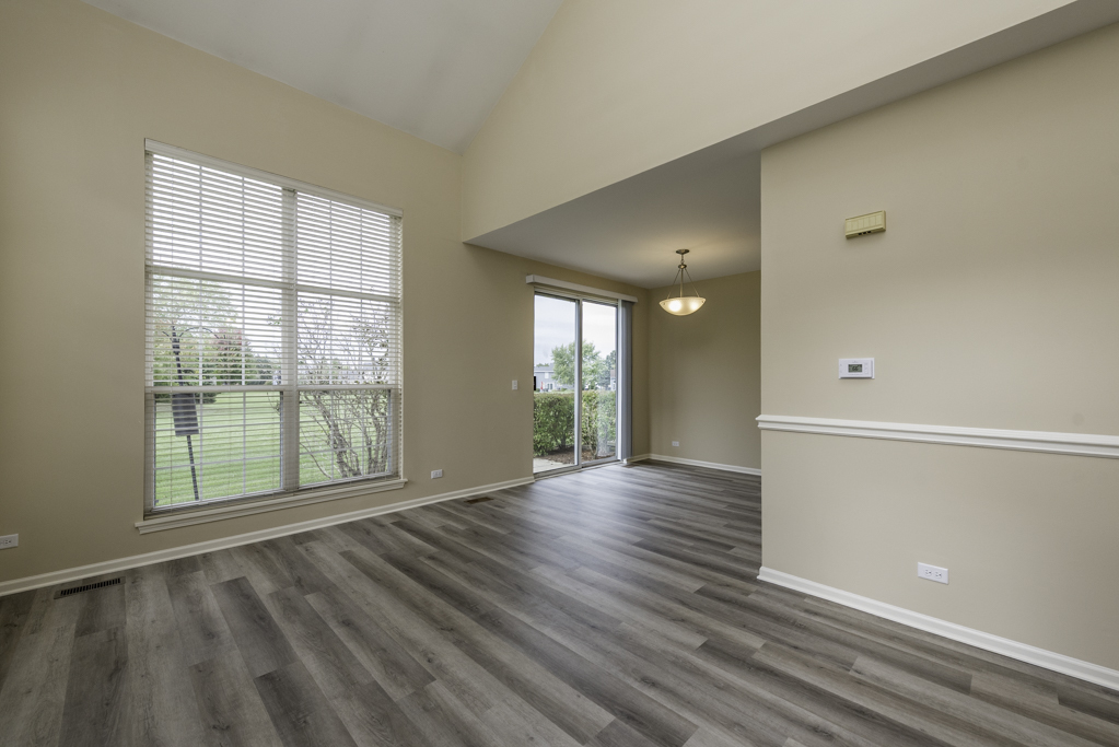 17876 Braewick Road Gurnee, IL 60031 - Photo 22 of 28 a view of an empty room with wooden floor and a window