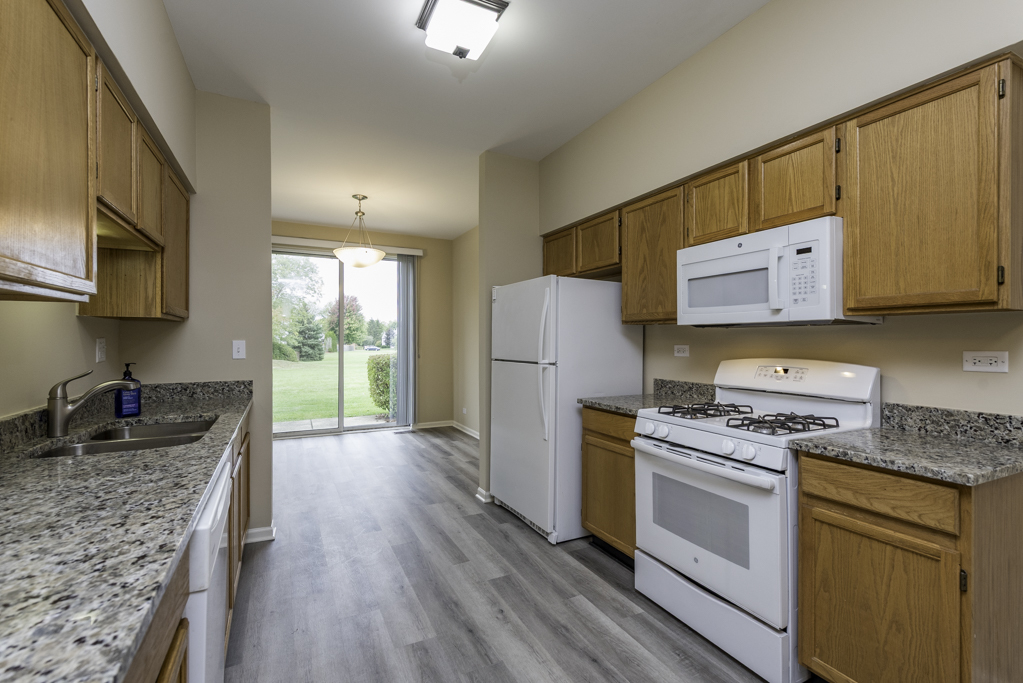 17876 Braewick Road Gurnee, IL 60031 - Photo 3 of 28 a kitchen with a refrigerator stove and sink