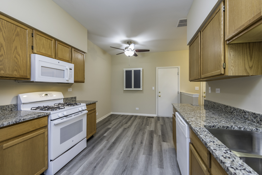 17876 Braewick Road Gurnee, IL 60031 - Photo 7 of 28 a kitchen with a sink stove and cabinets