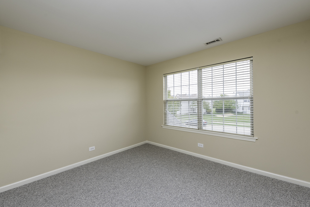 17876 Braewick Road Gurnee, IL 60031 - Photo 9 of 28 an empty room with a window