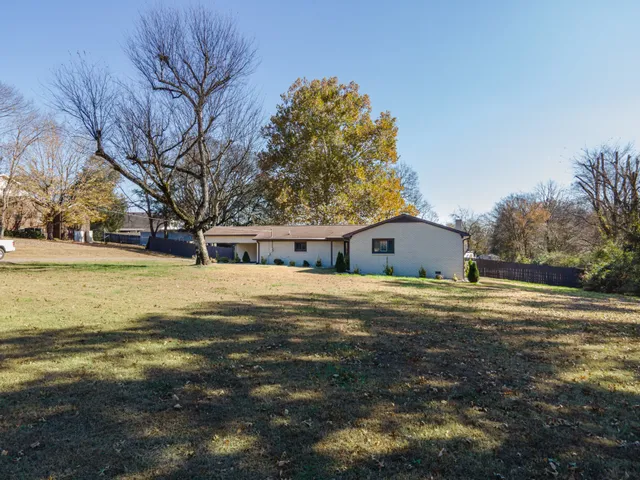 a front view of house with yard and trees