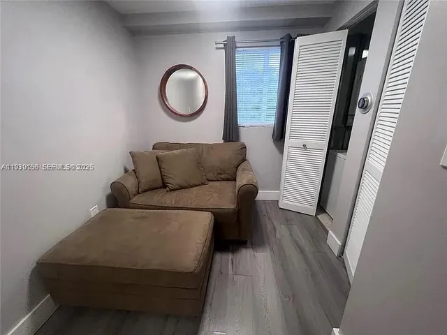 a living room with furniture and a mirror