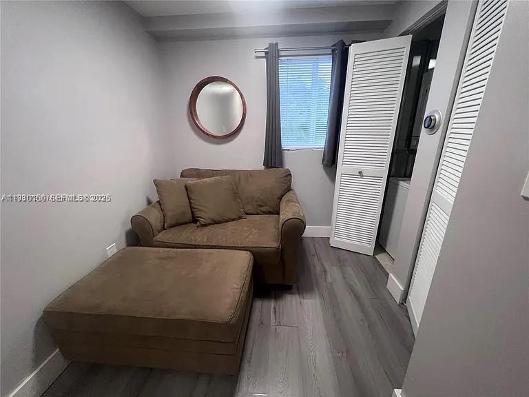 821 Southwest 2nd Street, Unit 2 Miami, FL 33130 - Photo 11 of 12 a living room with furniture and a mirror