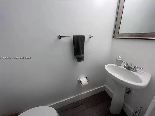a bathroom with a sink toilet and mirror