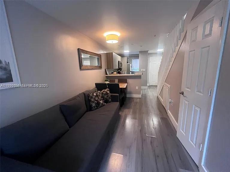 821 Southwest 2nd Street, Unit 2 Miami, FL 33130 - Photo 4 of 12 a living room with furniture and a wooden floor