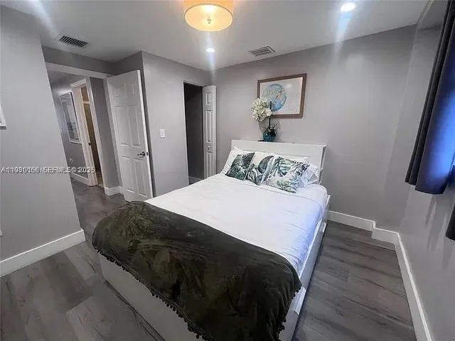 a bedroom with a bed and a mirror
