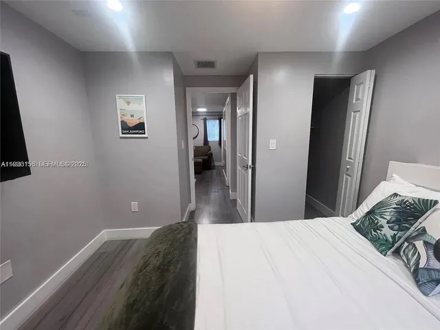 a bedroom with a bed and a mirror