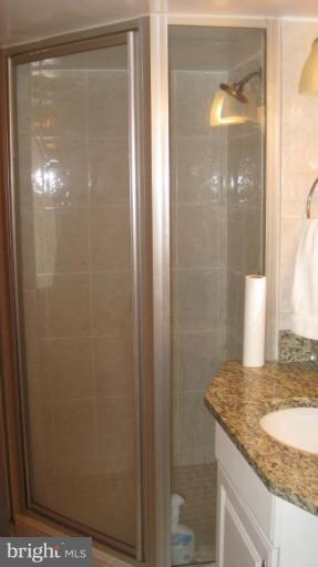 3109 Weller Road Silver Spring, MD 20906 - Photo 13 of 20 a bathroom with a granite countertop sink and a mirror