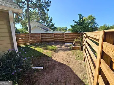 a view of a backyard with sitting area
