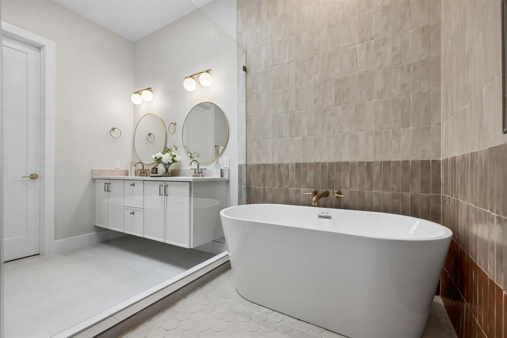 4615 Rusk Avenue Dallas, TX 75204 - Photo 17 of 25 a white bath tub sitting in a bathroom
