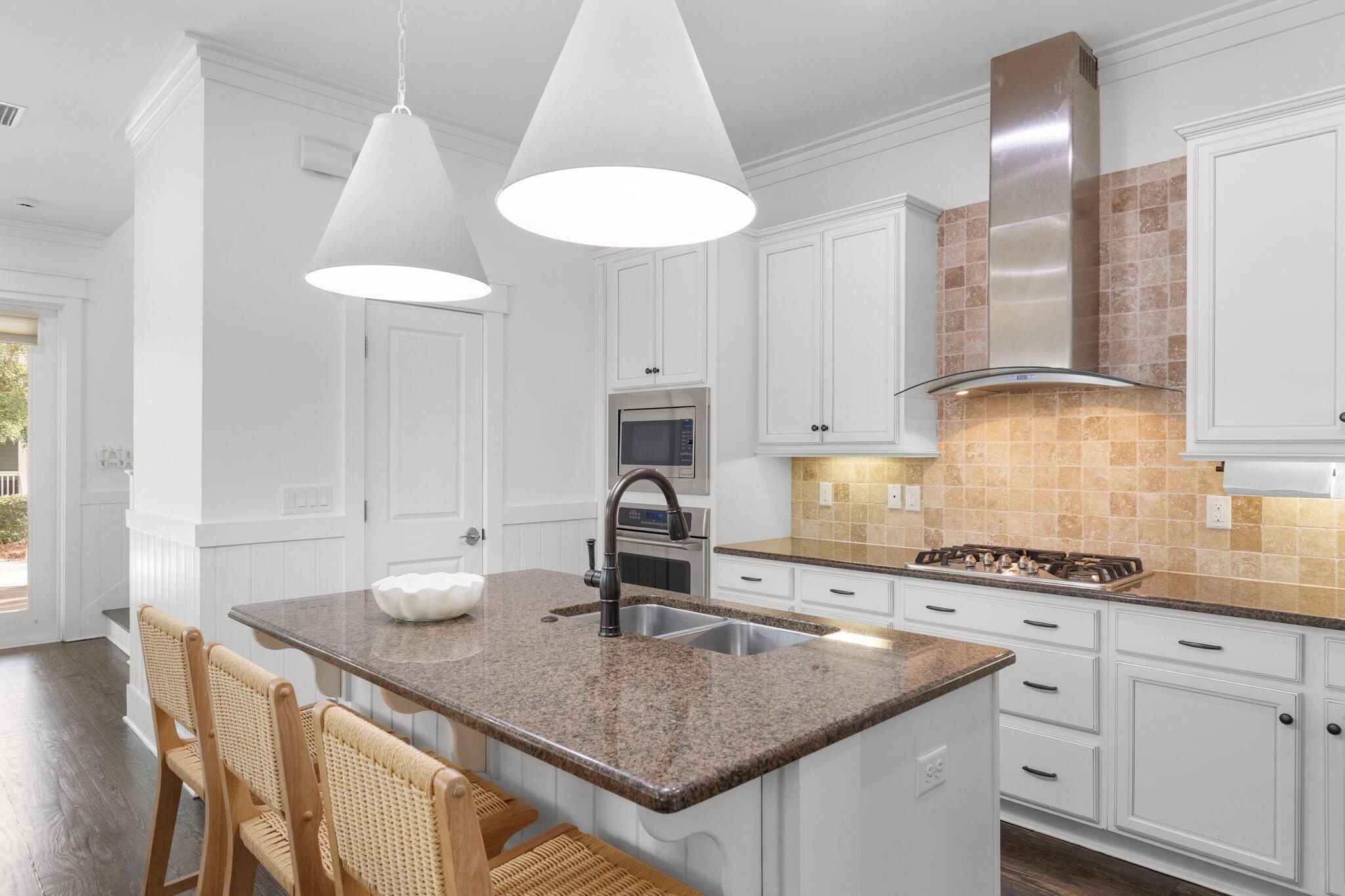 694 Flatwoods Forest Loop Santa Rosa Beach, FL 32459 - Photo 11 of 54 a kitchen with granite countertop a sink a stove and cabinets