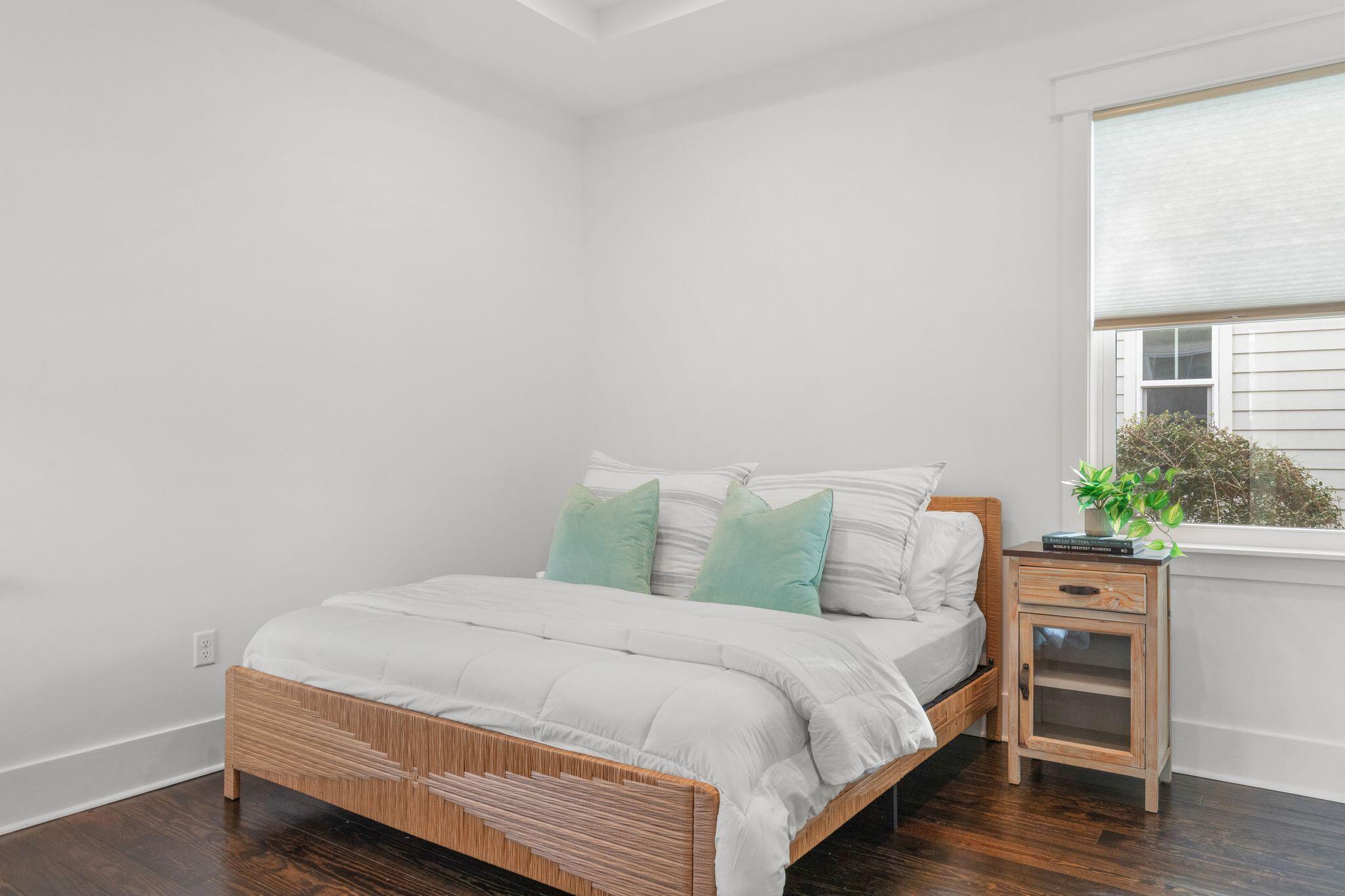 694 Flatwoods Forest Loop Santa Rosa Beach, FL 32459 - Photo 12 of 54 a bed sitting in a bedroom next to a window