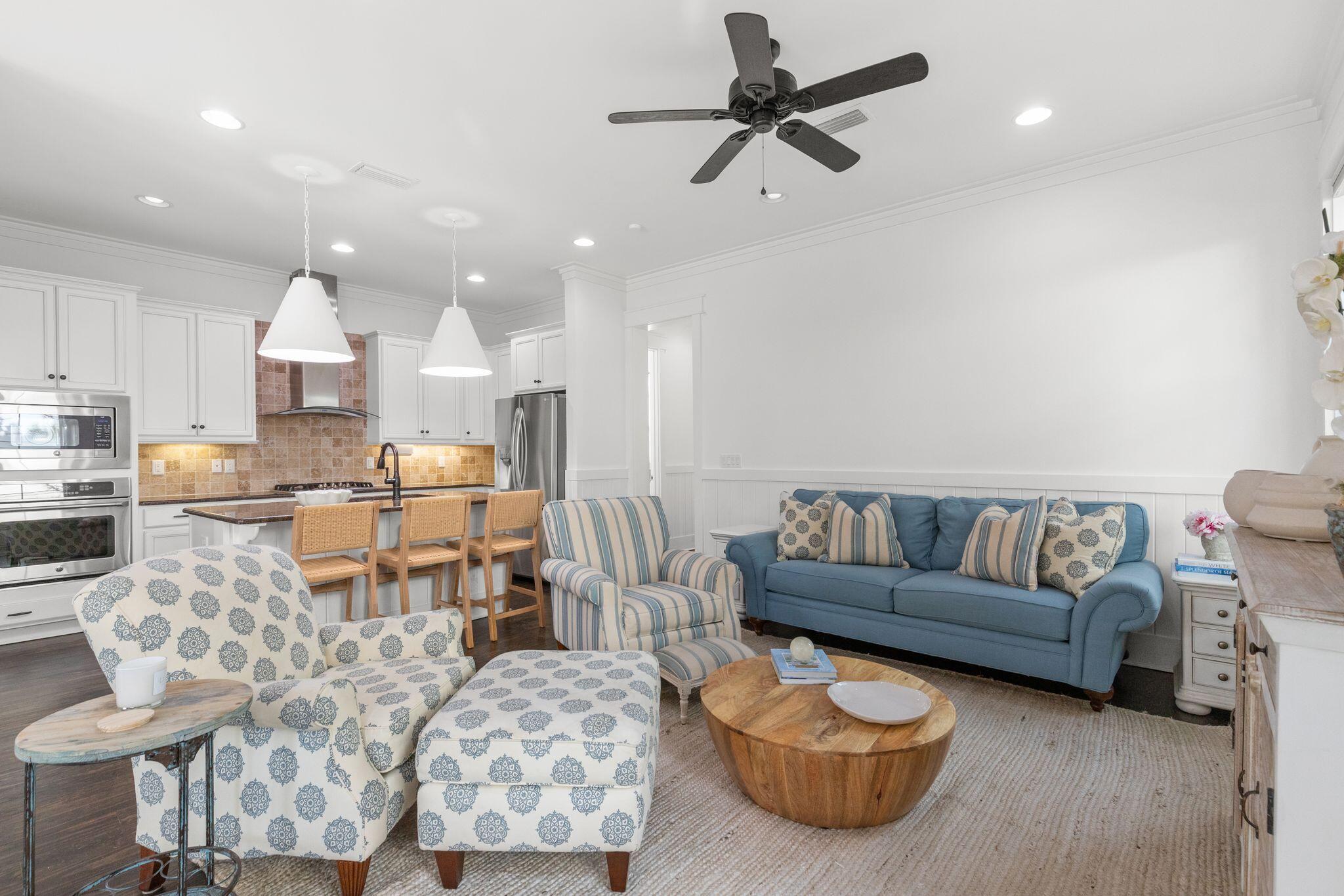 694 Flatwoods Forest Loop Santa Rosa Beach, FL 32459 - Photo 2 of 54 a living room with furniture kitchen view and a chandelier