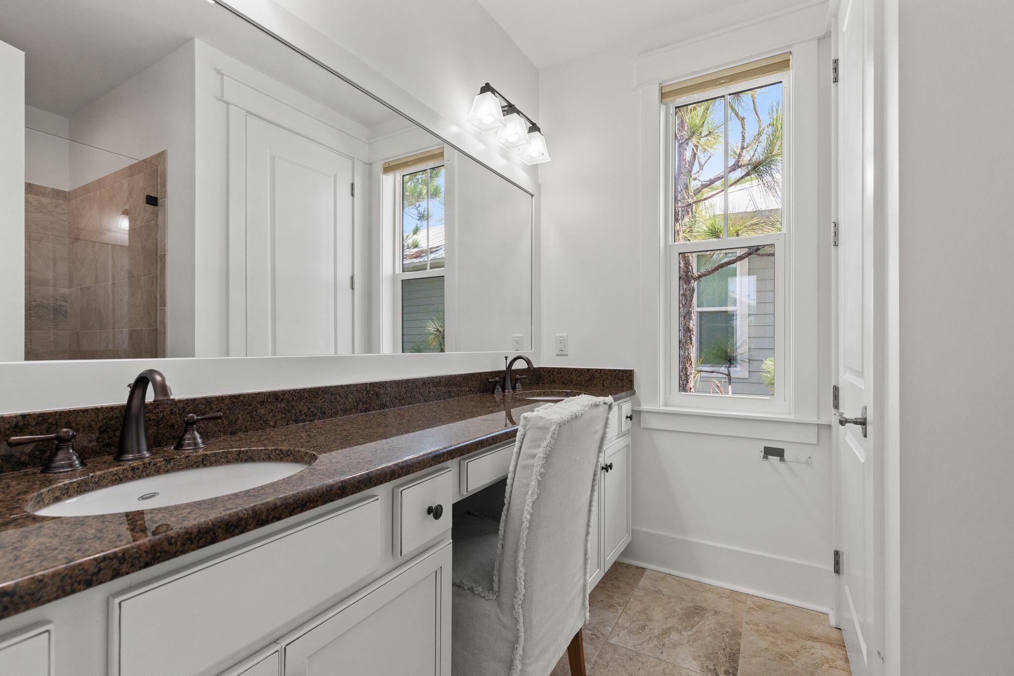694 Flatwoods Forest Loop Santa Rosa Beach, FL 32459 - Photo 21 of 54 a bathroom with a granite countertop sink and a mirror