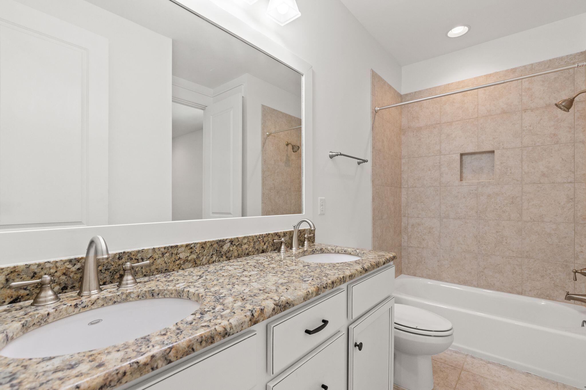 694 Flatwoods Forest Loop Santa Rosa Beach, FL 32459 - Photo 22 of 54 a bathroom with a granite countertop sink a toilet and bathtub