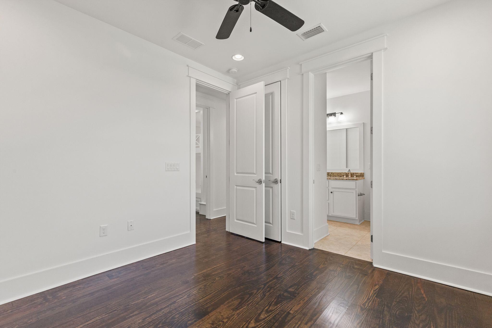 694 Flatwoods Forest Loop Santa Rosa Beach, FL 32459 - Photo 23 of 54 an empty room with wooden floor ceiling fan and window