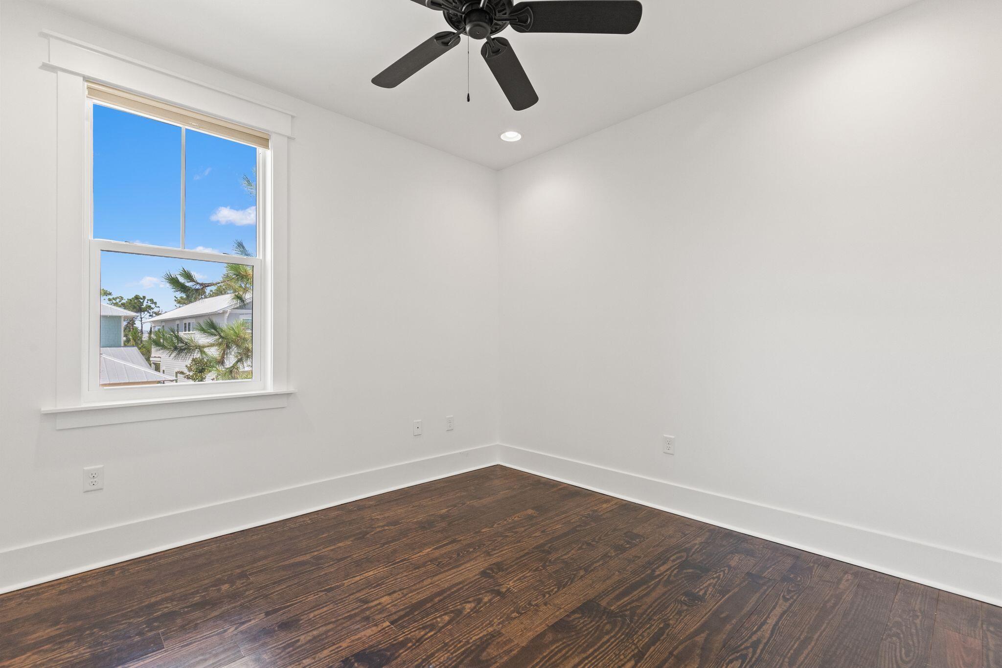 694 Flatwoods Forest Loop Santa Rosa Beach, FL 32459 - Photo 24 of 54 a view of an empty room with wooden floor and a window