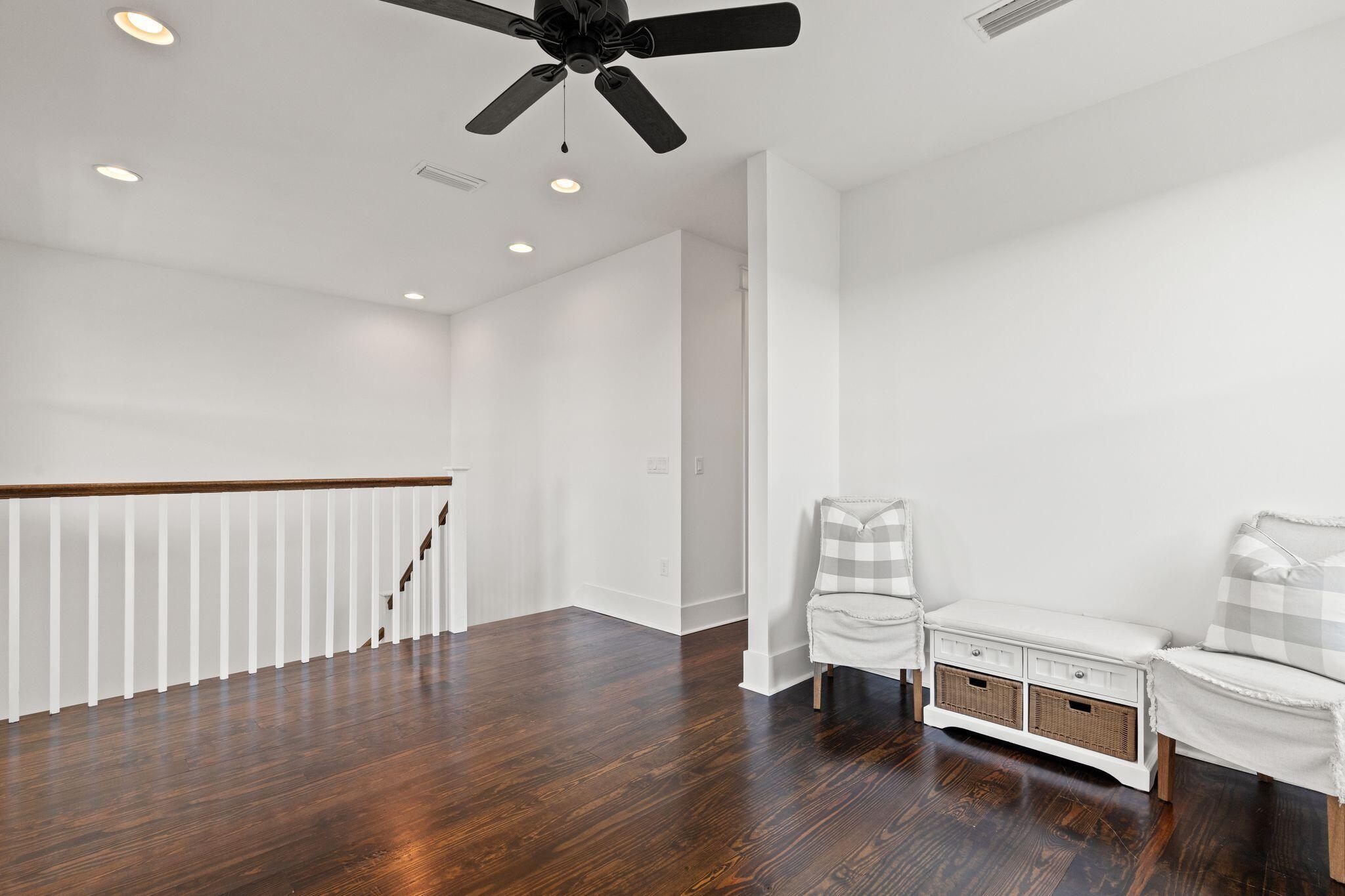 694 Flatwoods Forest Loop Santa Rosa Beach, FL 32459 - Photo 26 of 54 a view of a room with wooden floor lounge chair and windows