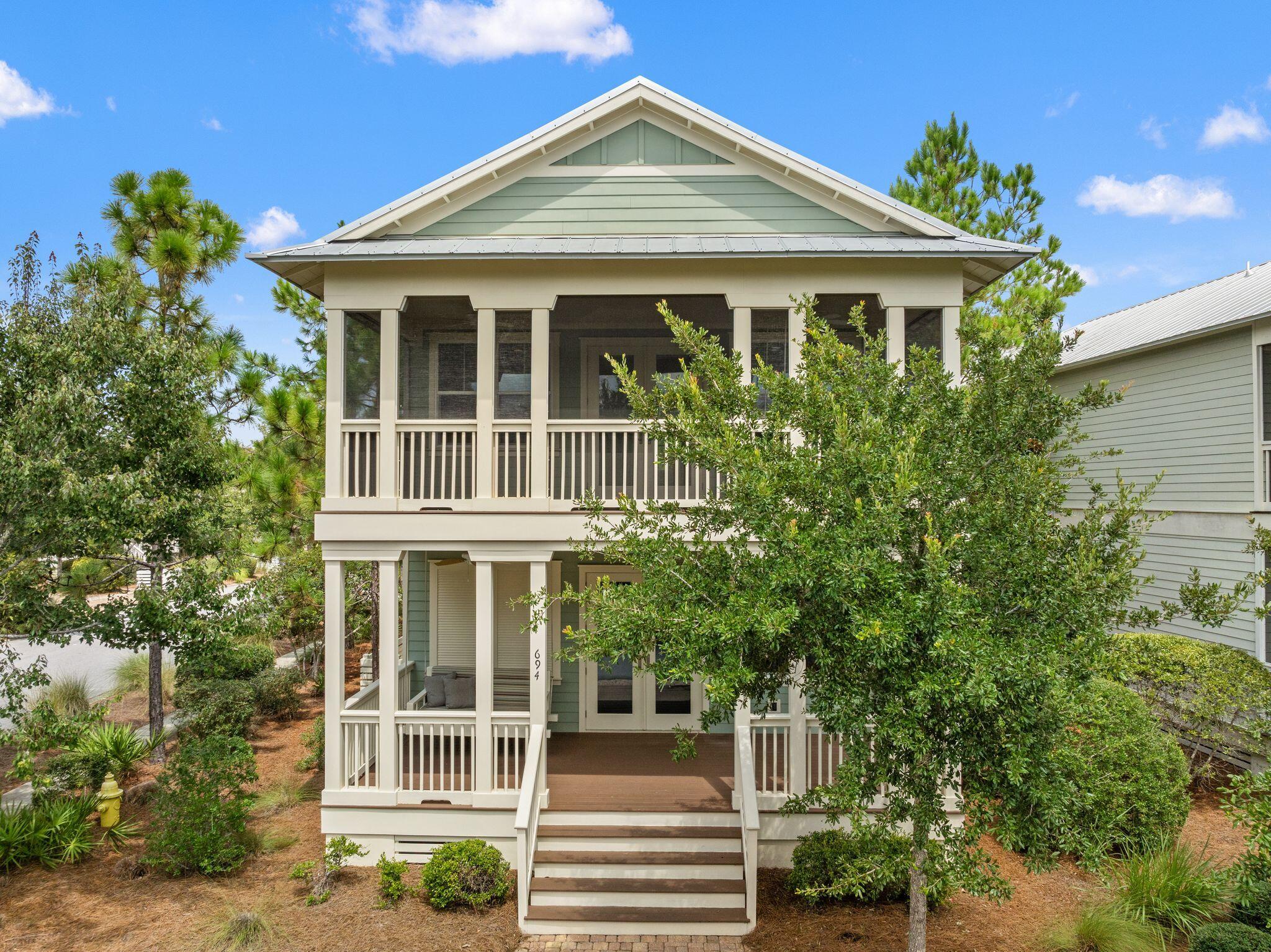 694 Flatwoods Forest Loop Santa Rosa Beach, FL 32459 - Photo 38 of 54 a front view of a house with a yard