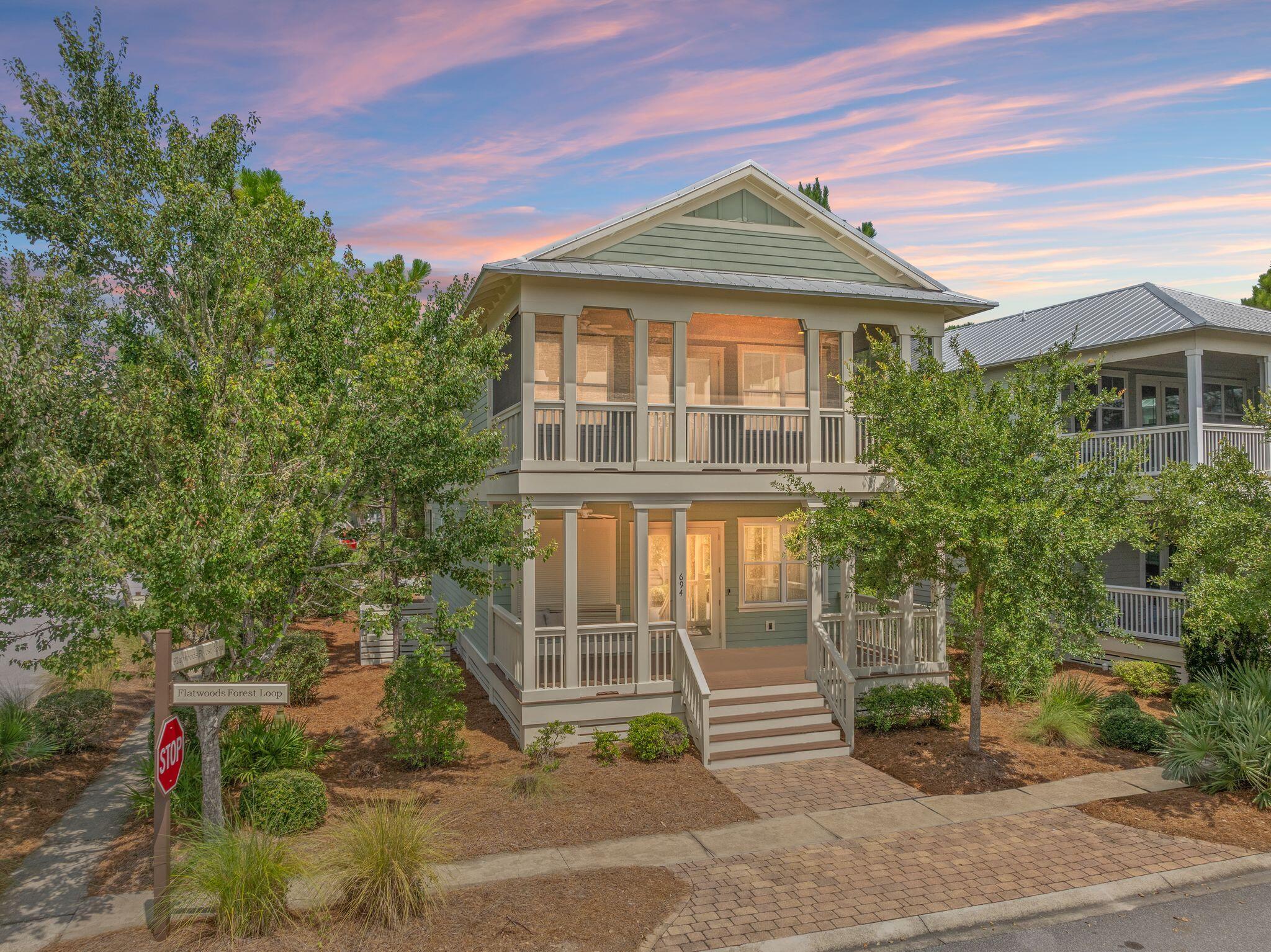 694 Flatwoods Forest Loop Santa Rosa Beach, FL 32459 - Photo 40 of 54 a front view of a house with a yard
