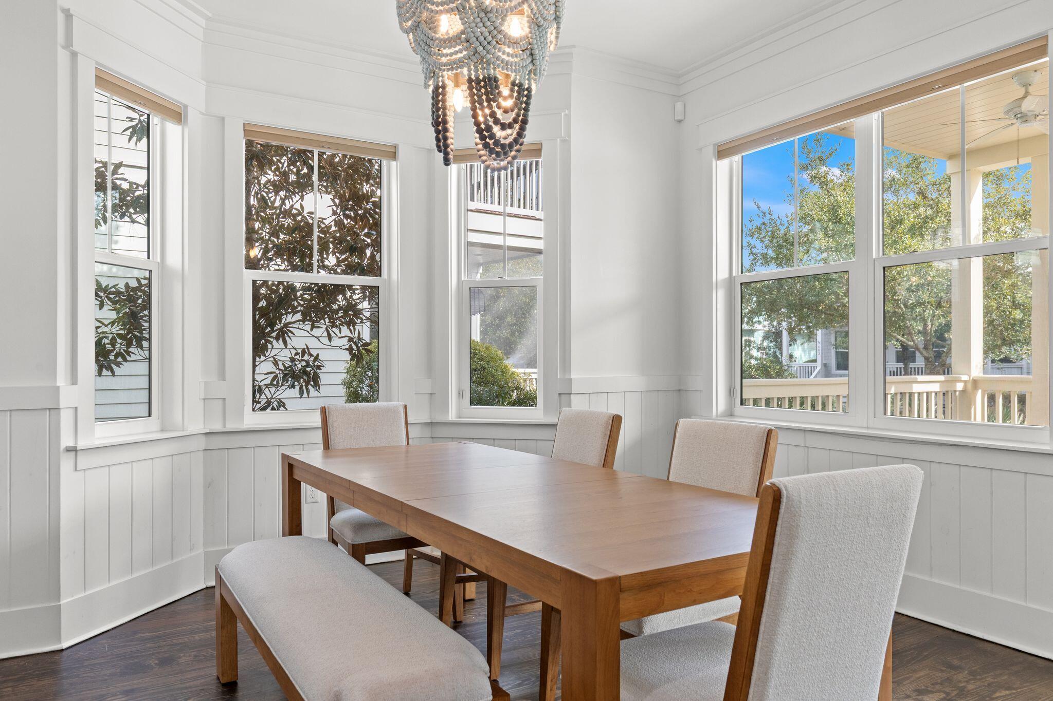 694 Flatwoods Forest Loop Santa Rosa Beach, FL 32459 - Photo 5 of 54 a view of a dining room with furniture window and wooden floor