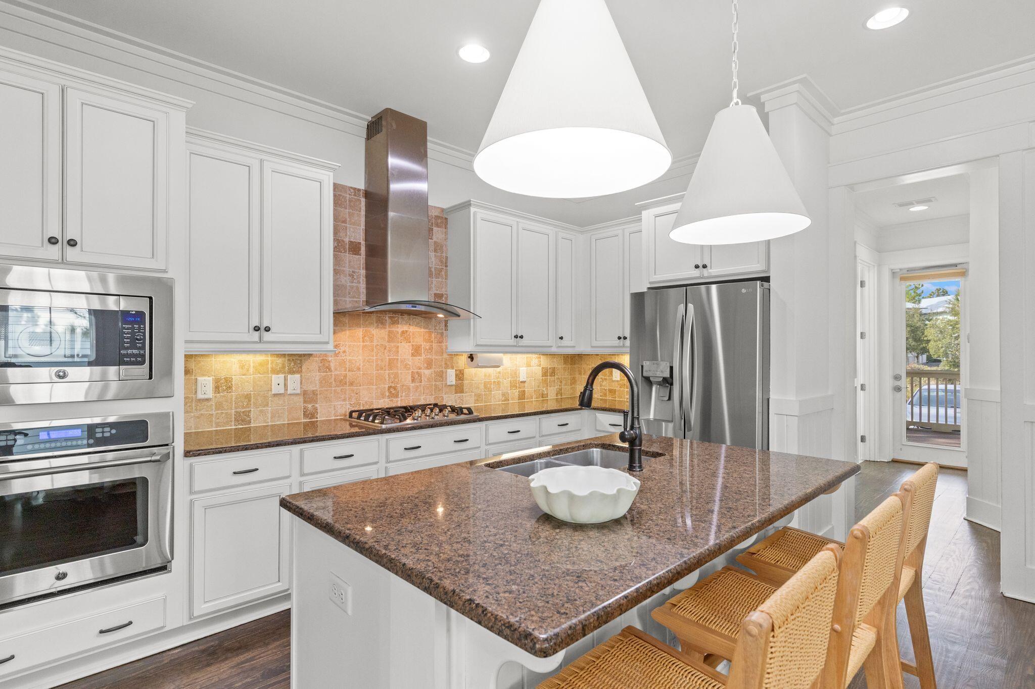 694 Flatwoods Forest Loop Santa Rosa Beach, FL 32459 - Photo 9 of 54 a kitchen with a table chairs and a stove