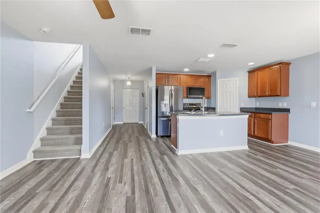 a kitchen with a refrigerator and a sink