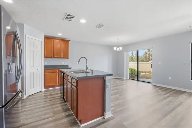a view of kitchen with refrigerator microwave and stove