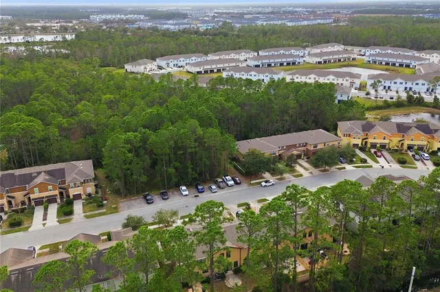 a view of a road with a garden and mountain view in back