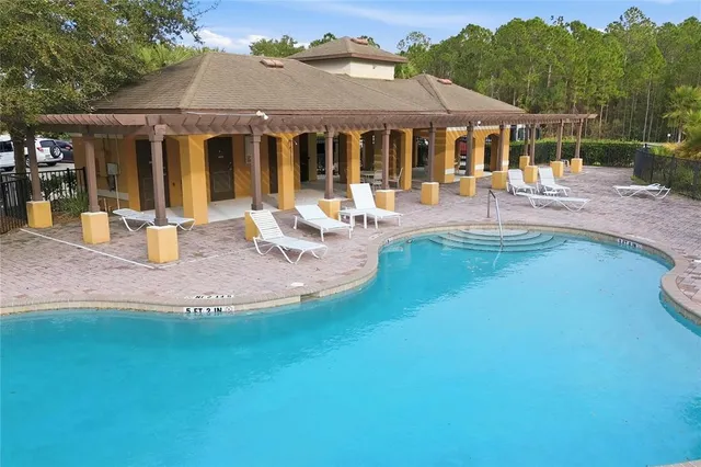 a view of house with yard and outdoor seating