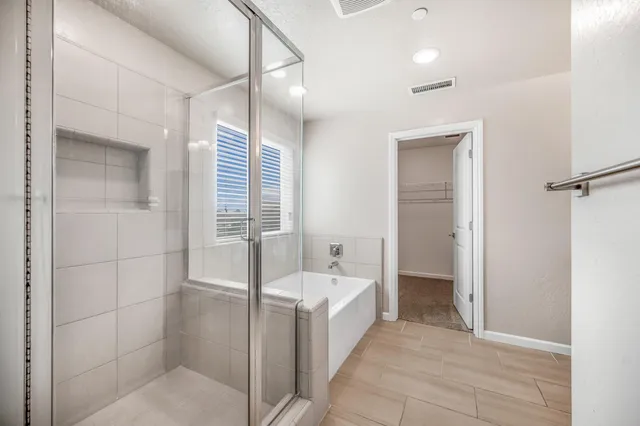 a bathroom with a granite countertop sink a mirror and a shower