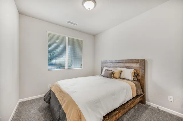 a bedroom with a bed and window