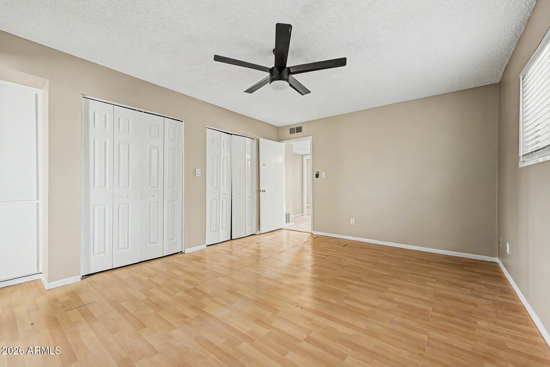 4007 West Mountain View Road Phoenix, AZ 85051 - Photo 18 of 31 a view of a room with wooden floor ceiling fan and window