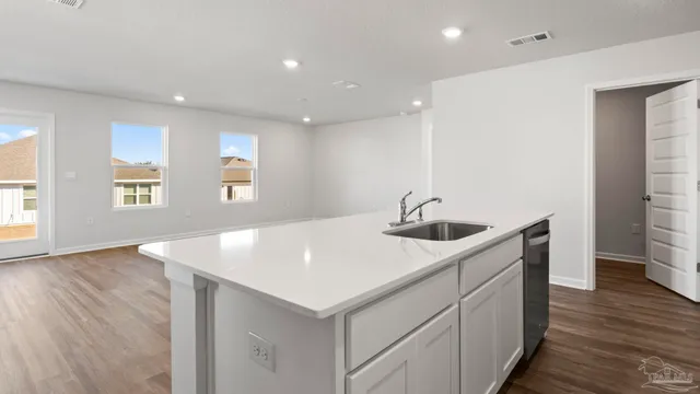 a kitchen with a sink a window and stainless steel appliances