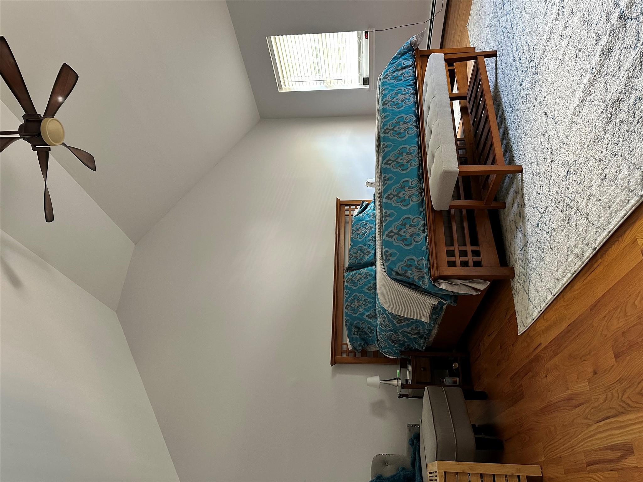 95 Weed Road Pine Bush, NY 12566 - Photo 10 of 31 Vaulted ceilings highlight this room featuring wood-finish flooring, a ceiling fan, and a window with horizontal blinds