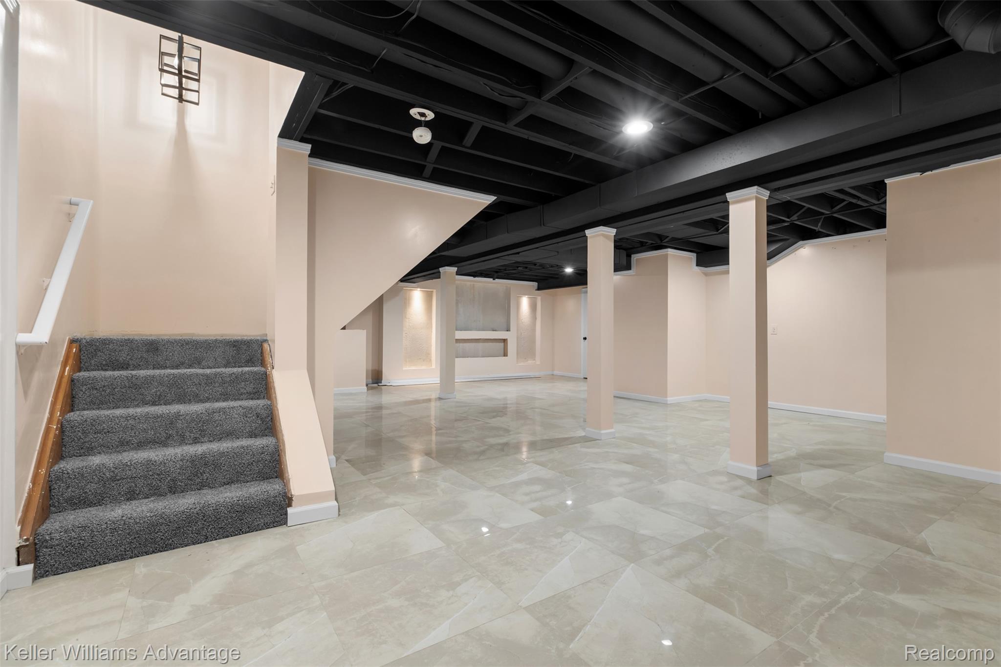 22627 Otter Road New Boston, MI 48164 - Photo 28 of 52 Spacious lower level featuring an exposed black ceiling, light-toned walls, and large format tile flooring