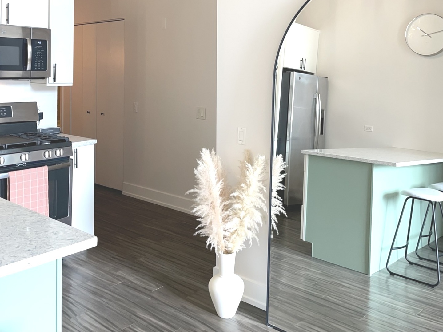 320 East 21st Street, Unit 215 Chicago, IL 60616 - Photo 5 of 18 a room with wooden floor and a chandelier