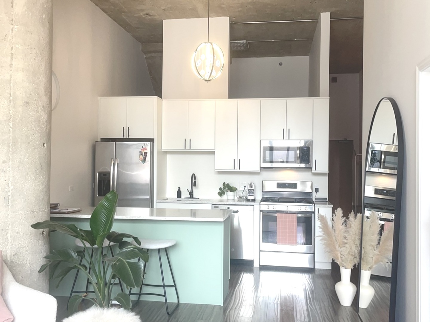 320 East 21st Street, Unit 215 Chicago, IL 60616 - Photo 6 of 18 a kitchen with stainless steel appliances a dining table chairs and a refrigerator