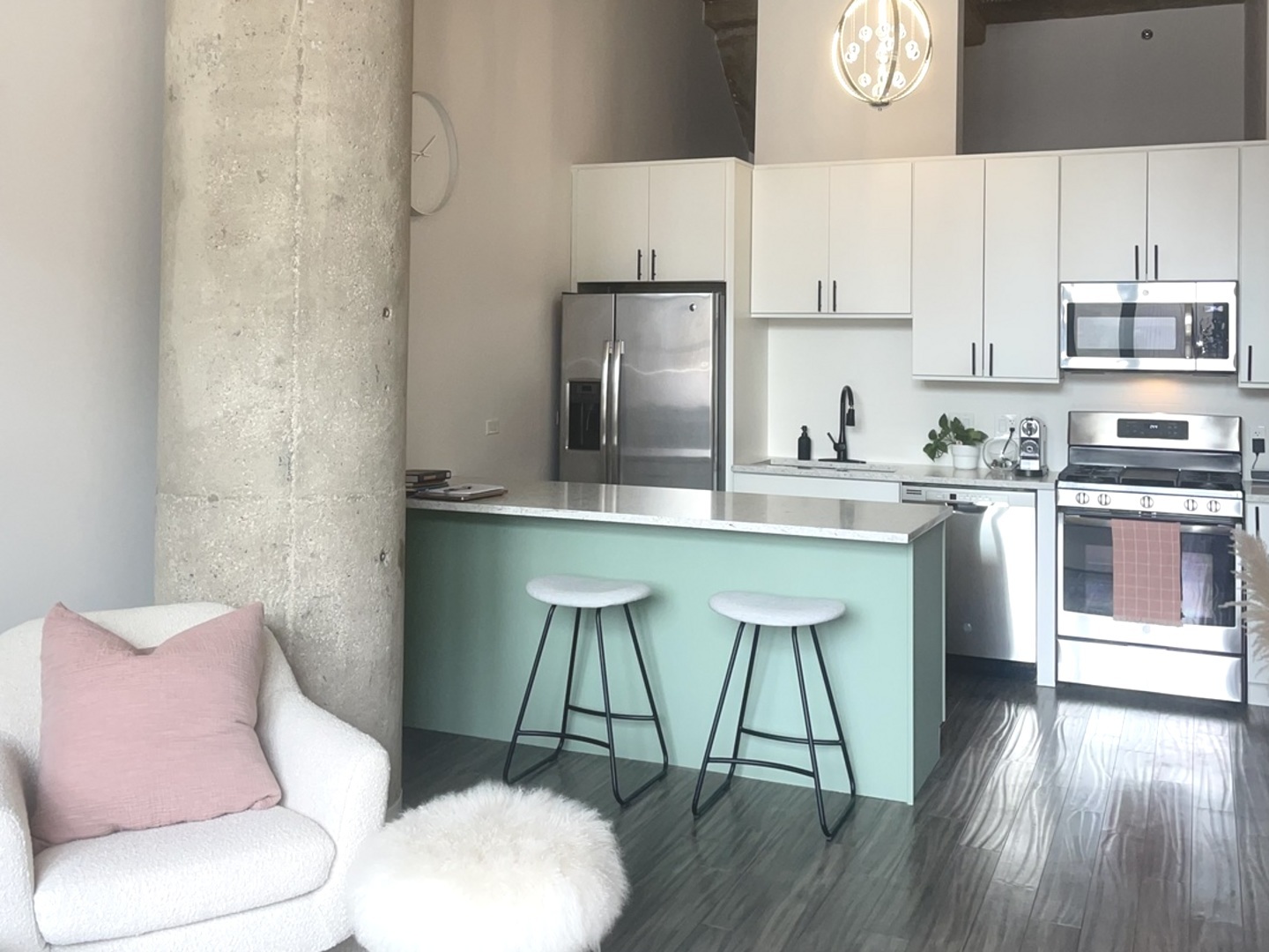 320 East 21st Street, Unit 215 Chicago, IL 60616 - Photo 7 of 18 a kitchen with stainless steel appliances a table and chairs in it