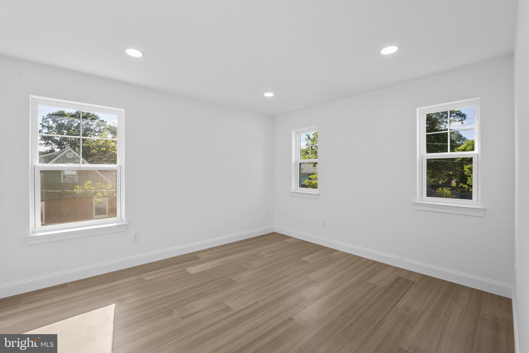 492 Ellis Avenue Lawnside, NJ 08045 - Photo 20 of 33 a view of an empty room with wooden floor and a window
