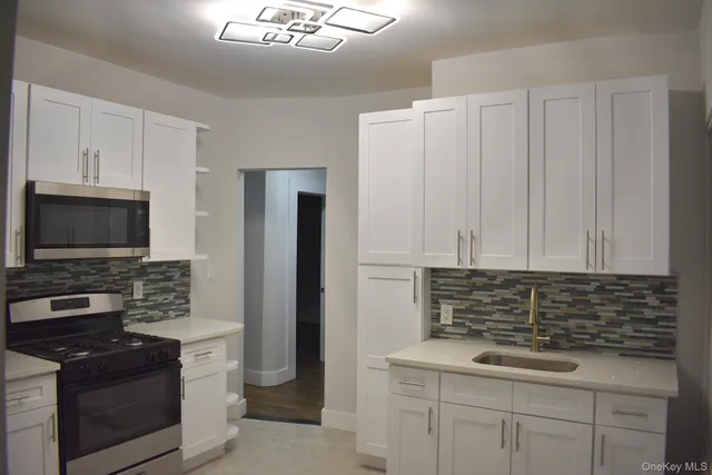 a kitchen with appliances cabinets and a sink