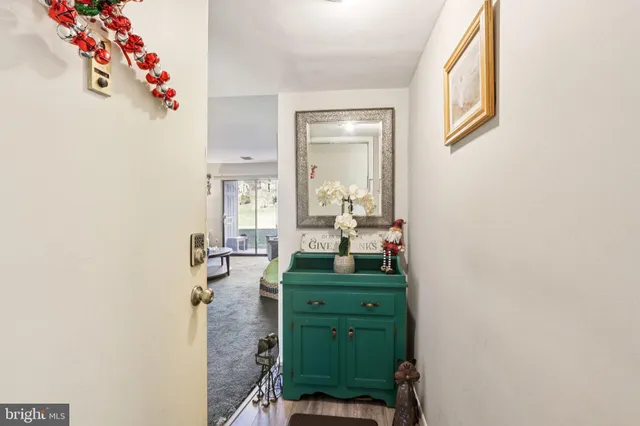 a living room with furniture a flat screen tv and a window