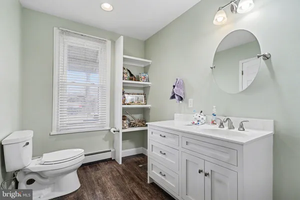 a bathroom with a tub a sink and a mirror