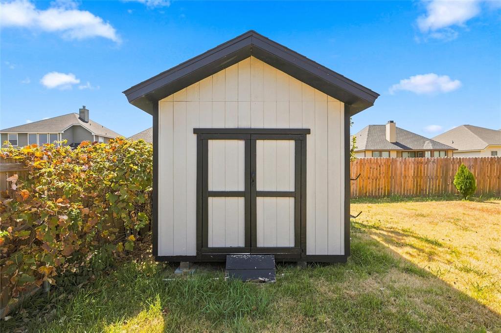 10409 Condor Loop Waco, TX 76708 - Photo 25 of 26 Detached storage shed featuring board and batten siding, black trim, and a gabled roof